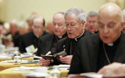 Members of the U.S. Conference of Catholic Bishops pray before the second day of proceedings at the bishops' annual fall meeting Nov. 12 in Baltimore. (CNS photo/Nancy Phelan Wiechec)